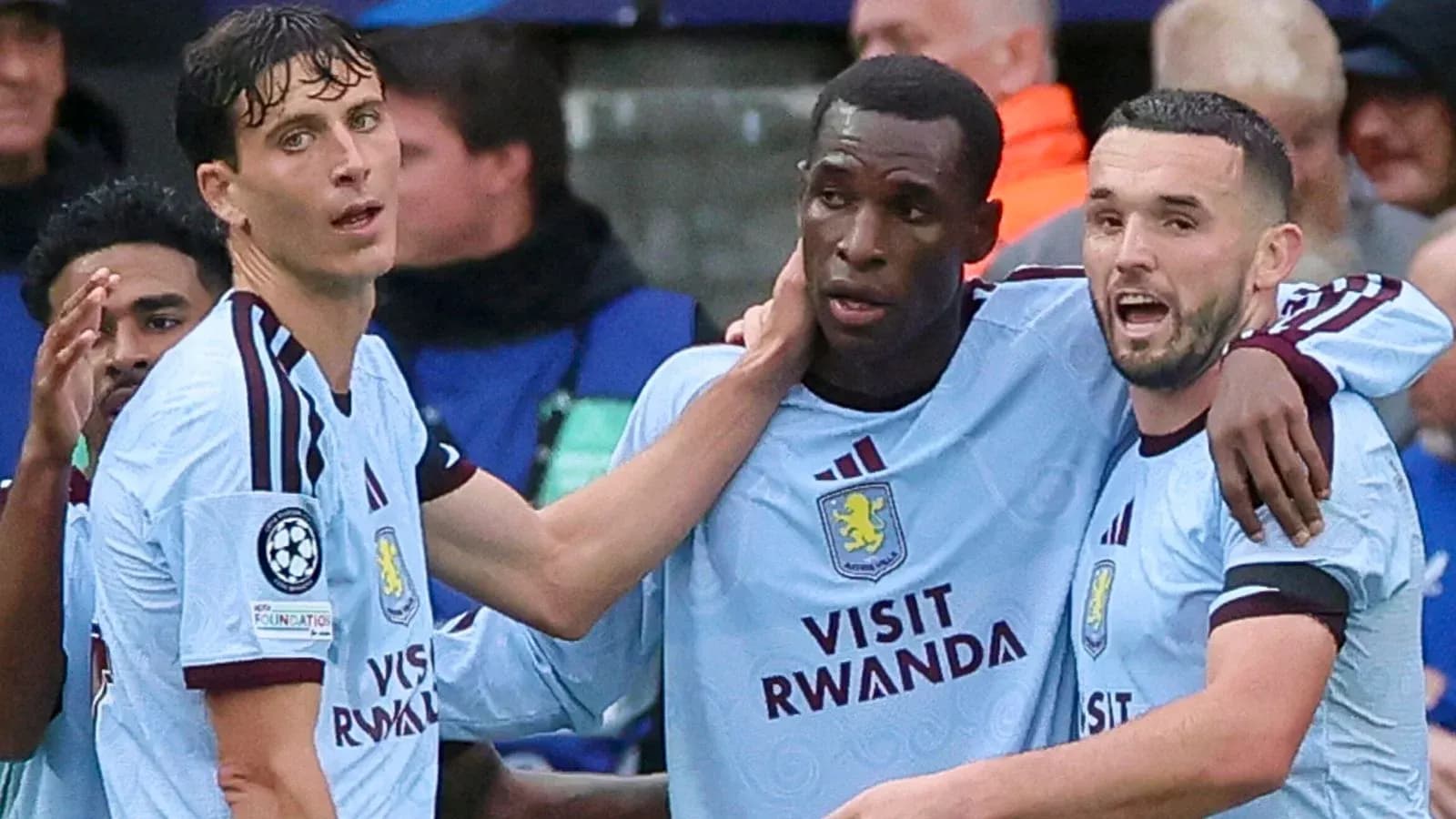 Three Aston Villa players celebrating a goal together Three Aston Villa players celebrating a goal together
