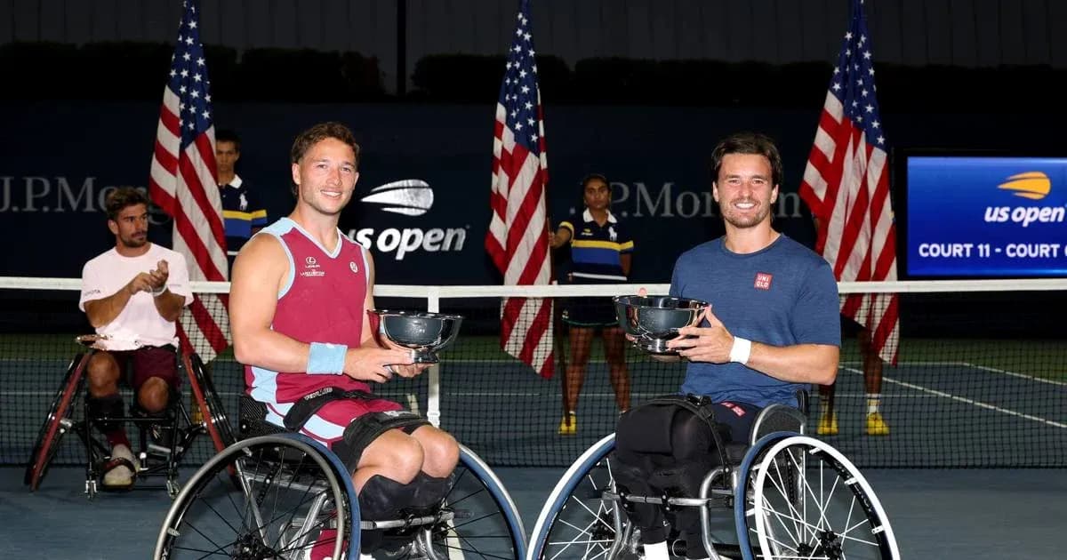 Two wheelchair tennis players holding trophies after match Two wheelchair tennis players holding trophies after match