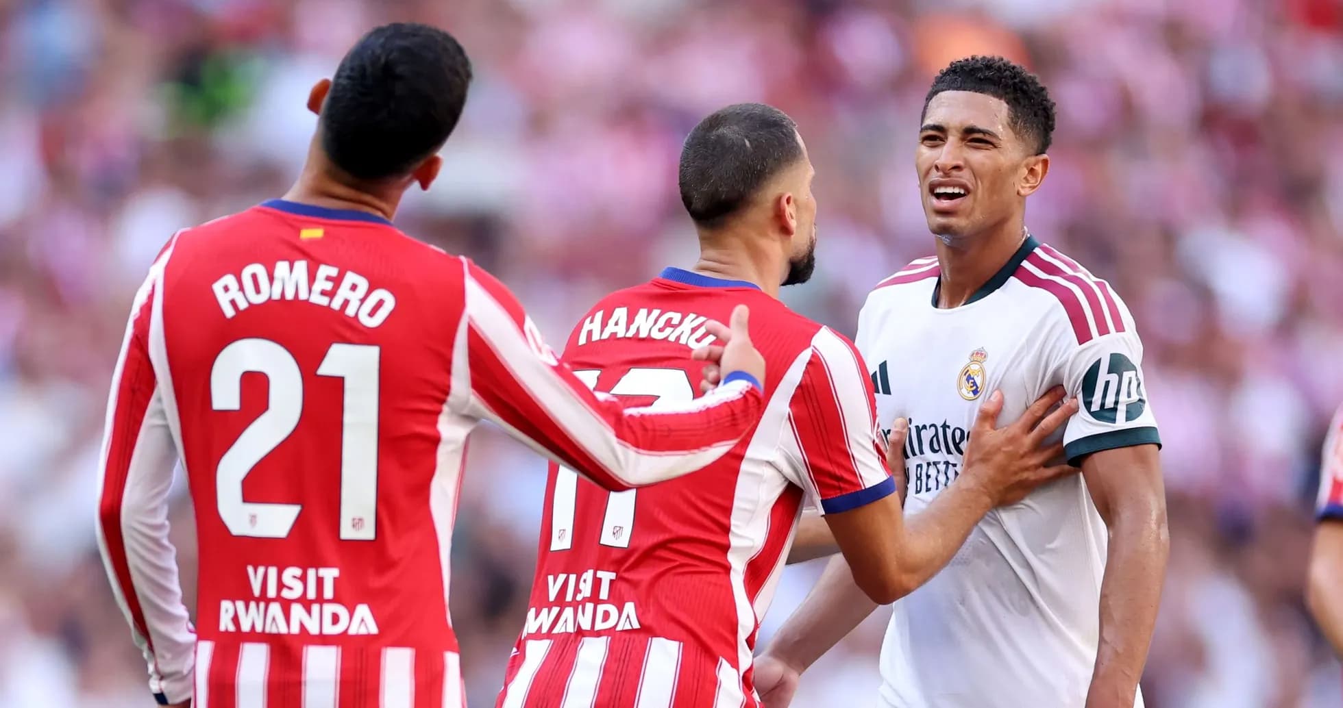 Atletico players confronting Real Madrid player on field Atletico players confronting Real Madrid player on field
