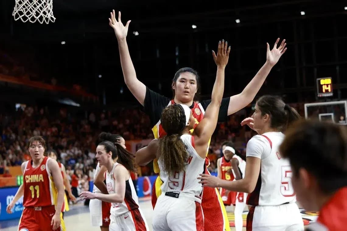 Players contesting during a basketball match Players contesting during a basketball match