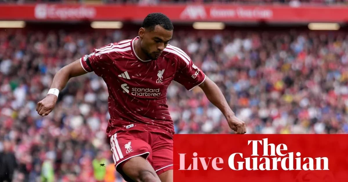 Liverpool player dribbling during a match at Anfield Liverpool player dribbling during a match at Anfield