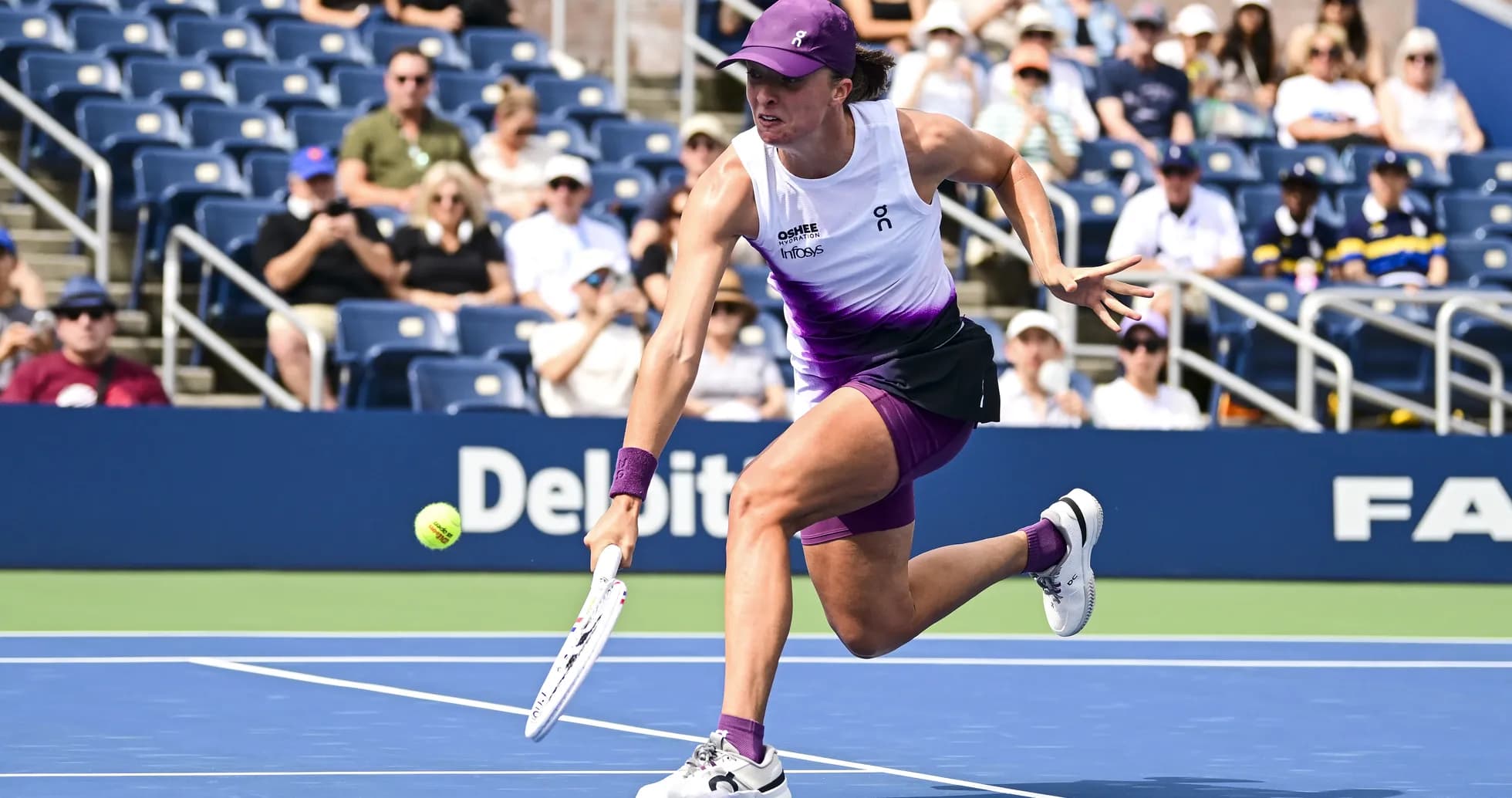 Player reaching for a tennis ball during match Player reaching for a tennis ball during match