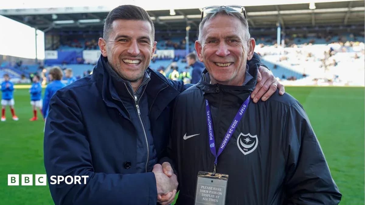 Two men smiling and shaking hands on the pitch Two men smiling and shaking hands on the pitch