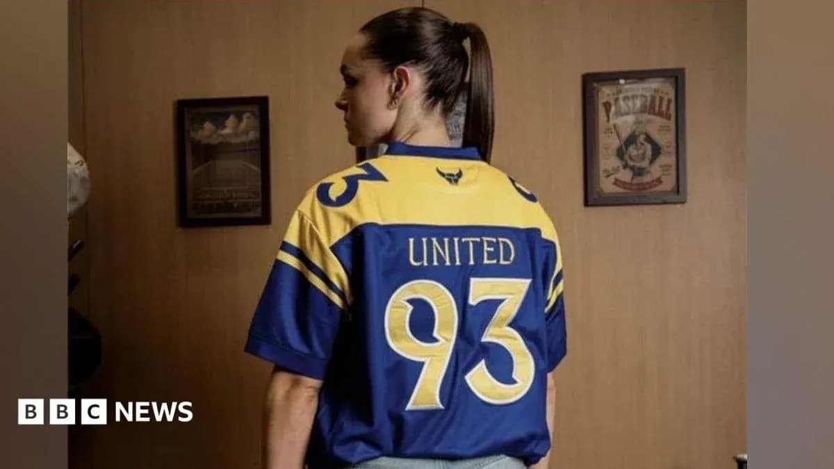 Person wearing a blue and yellow jersey with 'United 93' Person wearing a blue and yellow jersey with 'United 93'