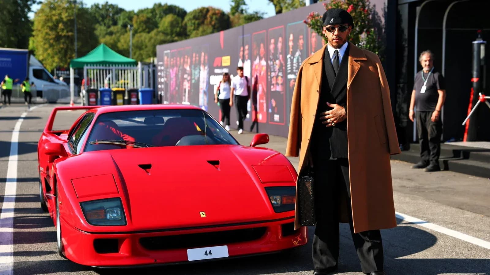 Person in stylish coat beside red Ferrari F40 Person in stylish coat beside red Ferrari F40