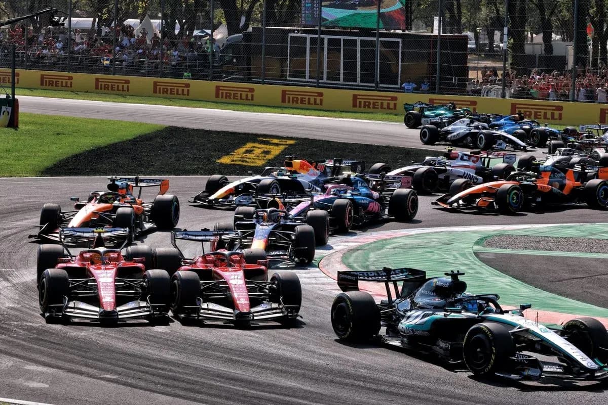 Formula 1 cars racing at a tight corner Formula 1 cars racing at a tight corner