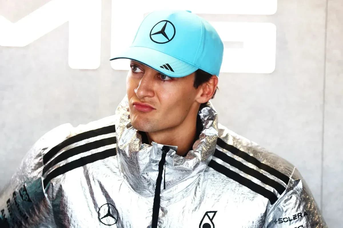Driver wearing a silver jacket and blue cap Driver wearing a silver jacket and blue cap