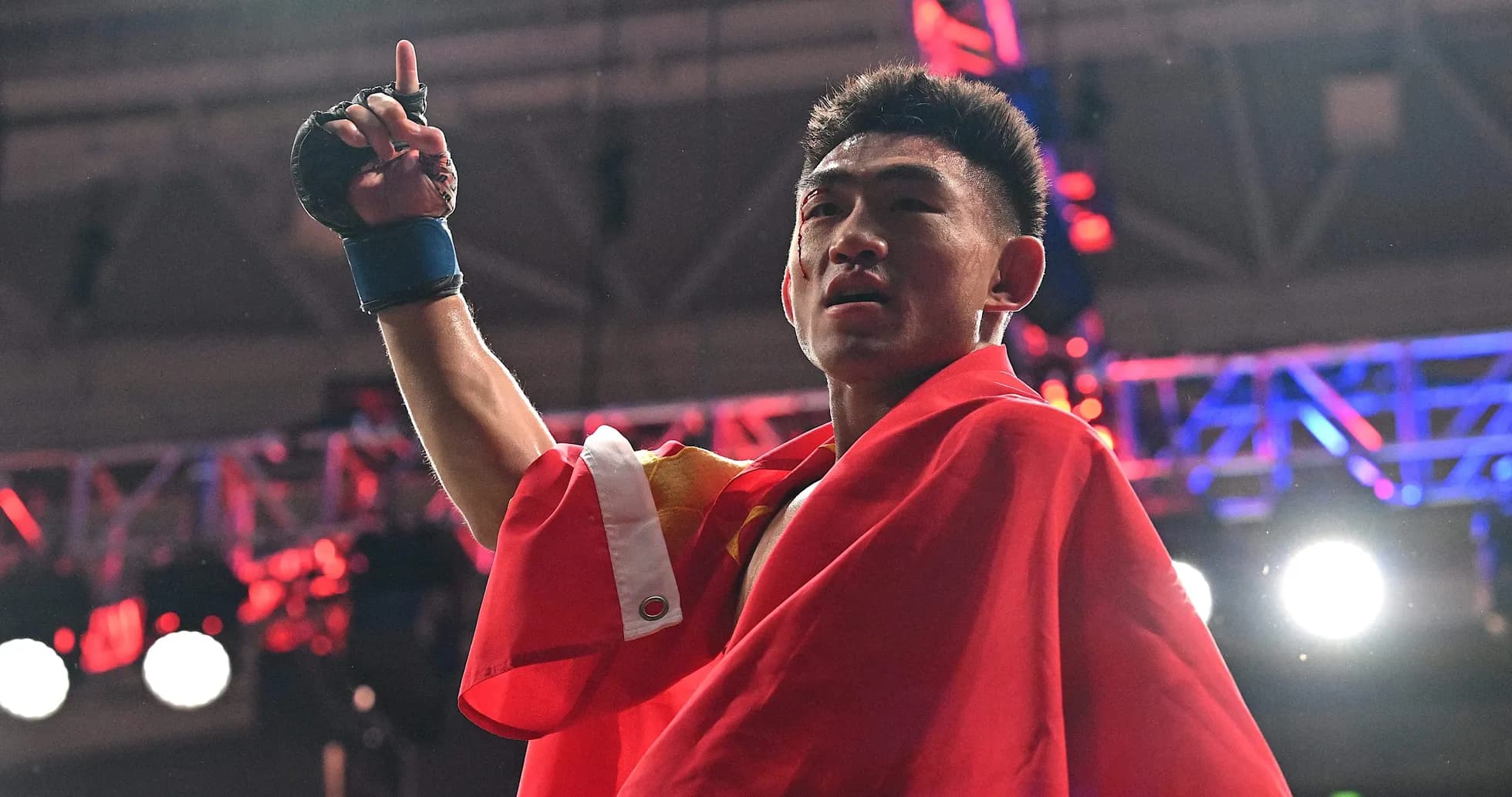 Boxer celebrating victory while holding a flag Boxer celebrating victory while holding a flag