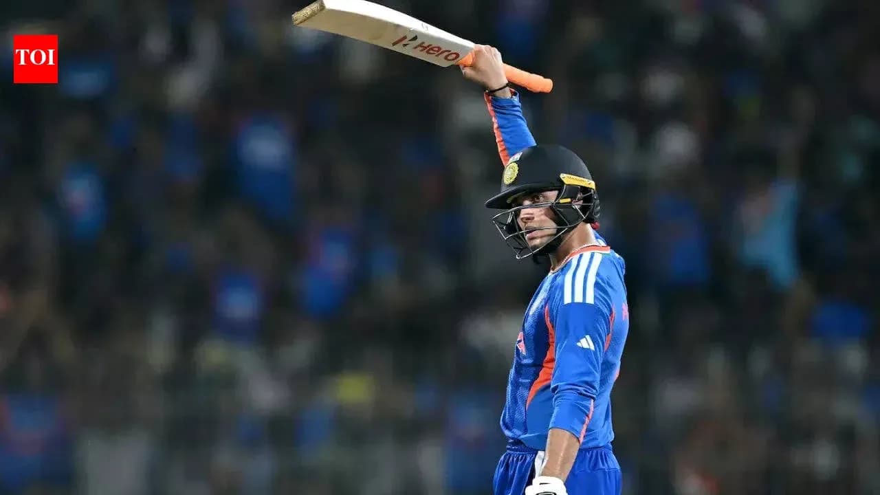 Cricketer celebrating with bat raised in air Cricketer celebrating with bat raised in air