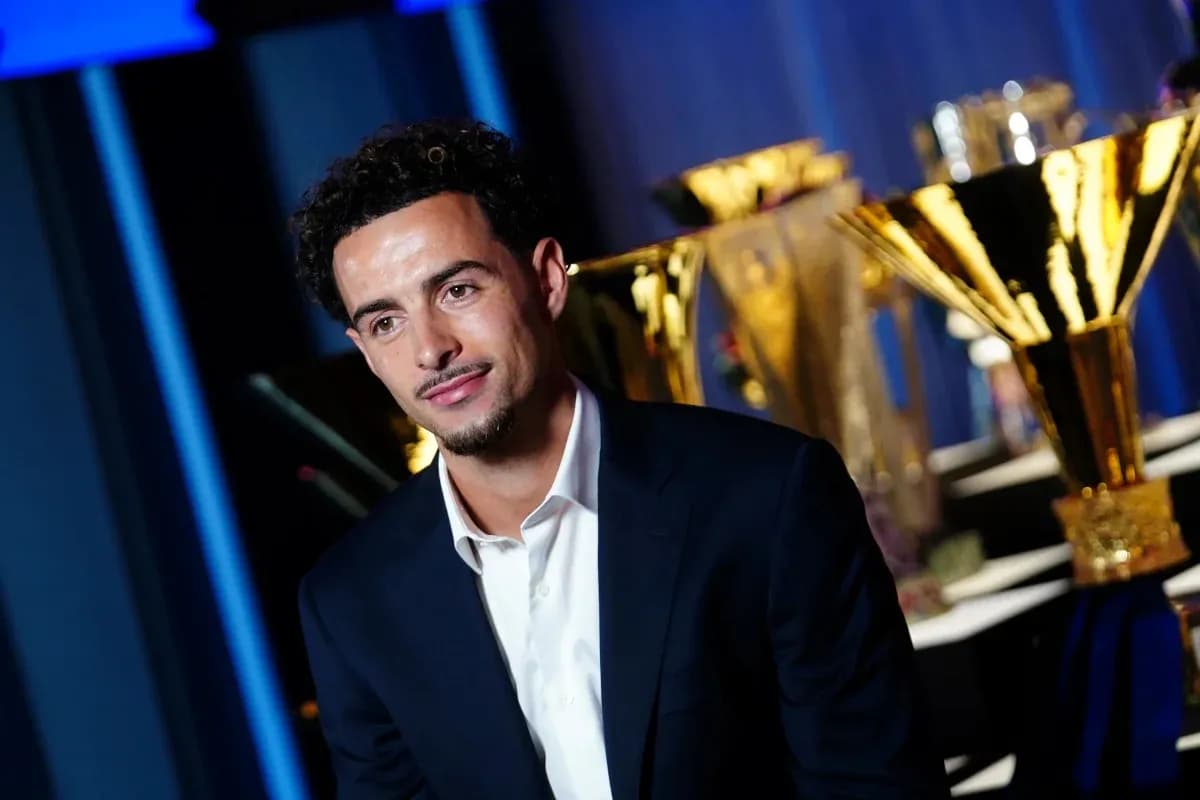 Player posing with trophies in background Player posing with trophies in background