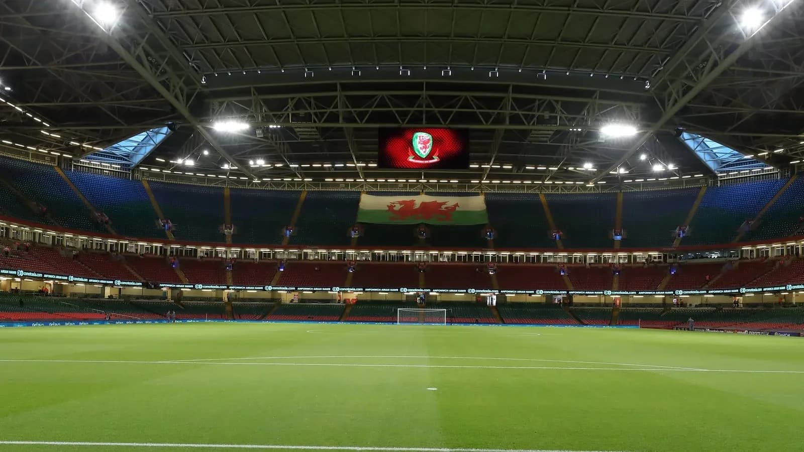Empty stadium with Welsh flag displayed prominently Empty stadium with Welsh flag displayed prominently