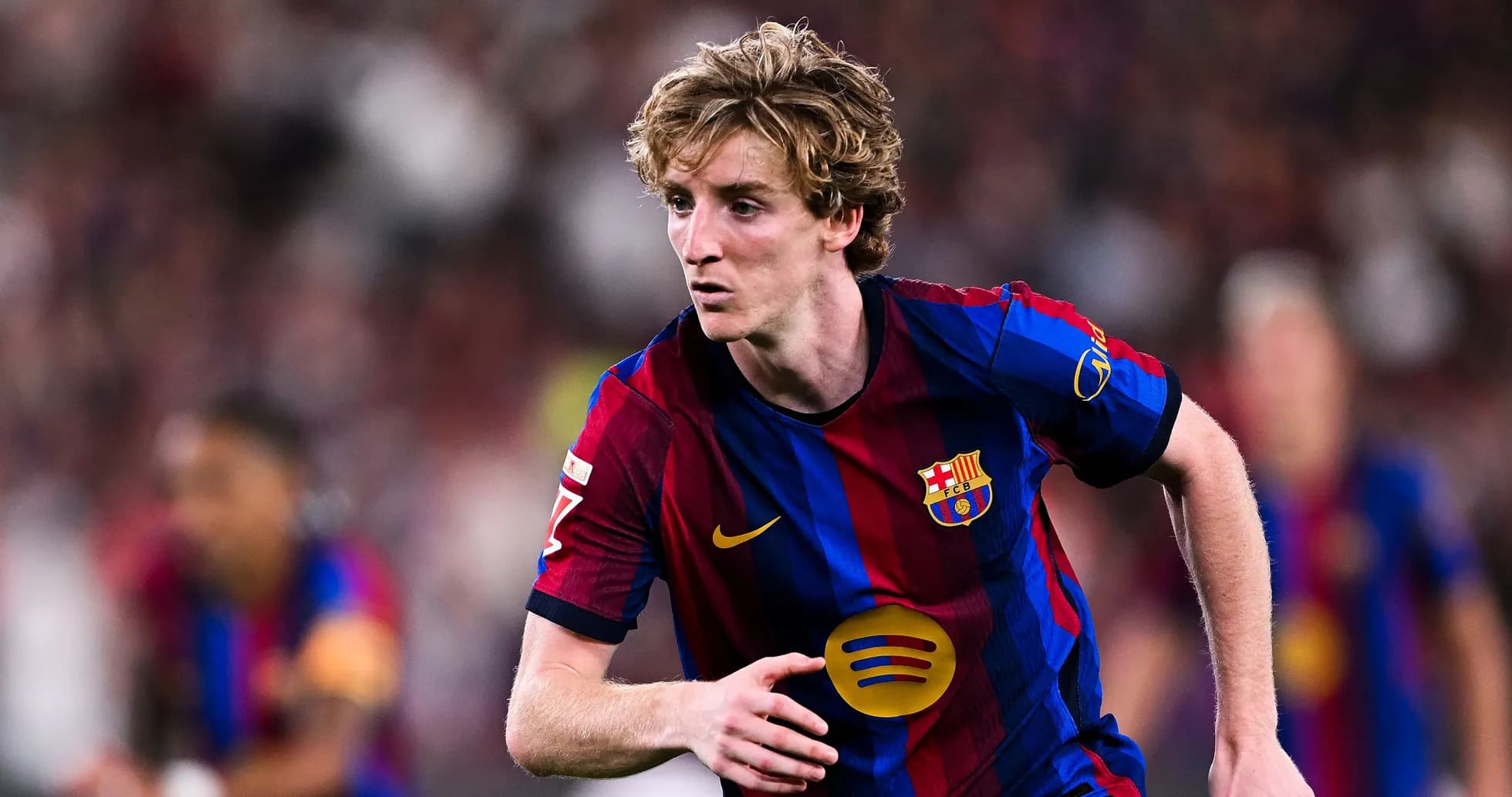 Player in FC Barcelona kit running during match Player in FC Barcelona kit running during match