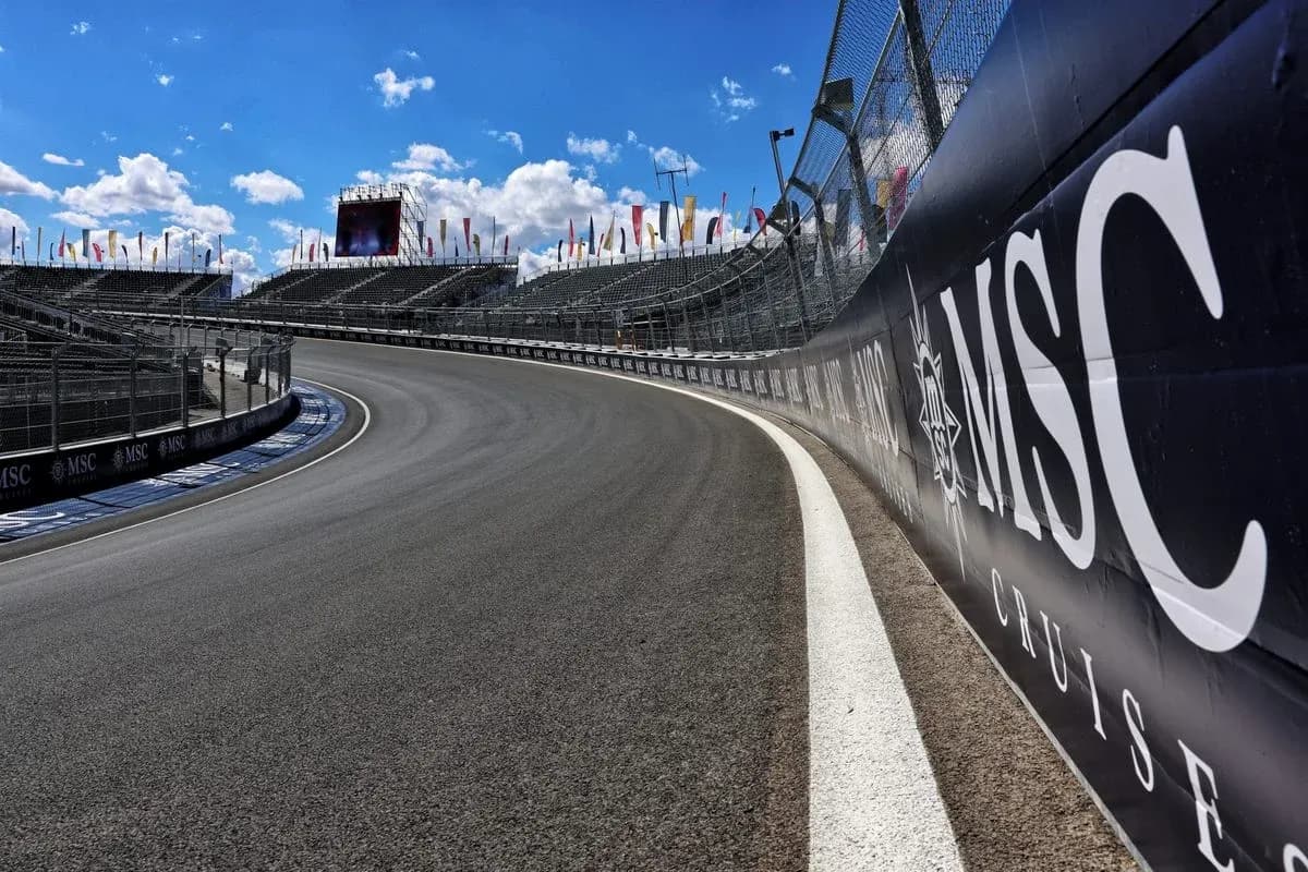Curved racetrack with grandstands and blue sky Curved racetrack with grandstands and blue sky