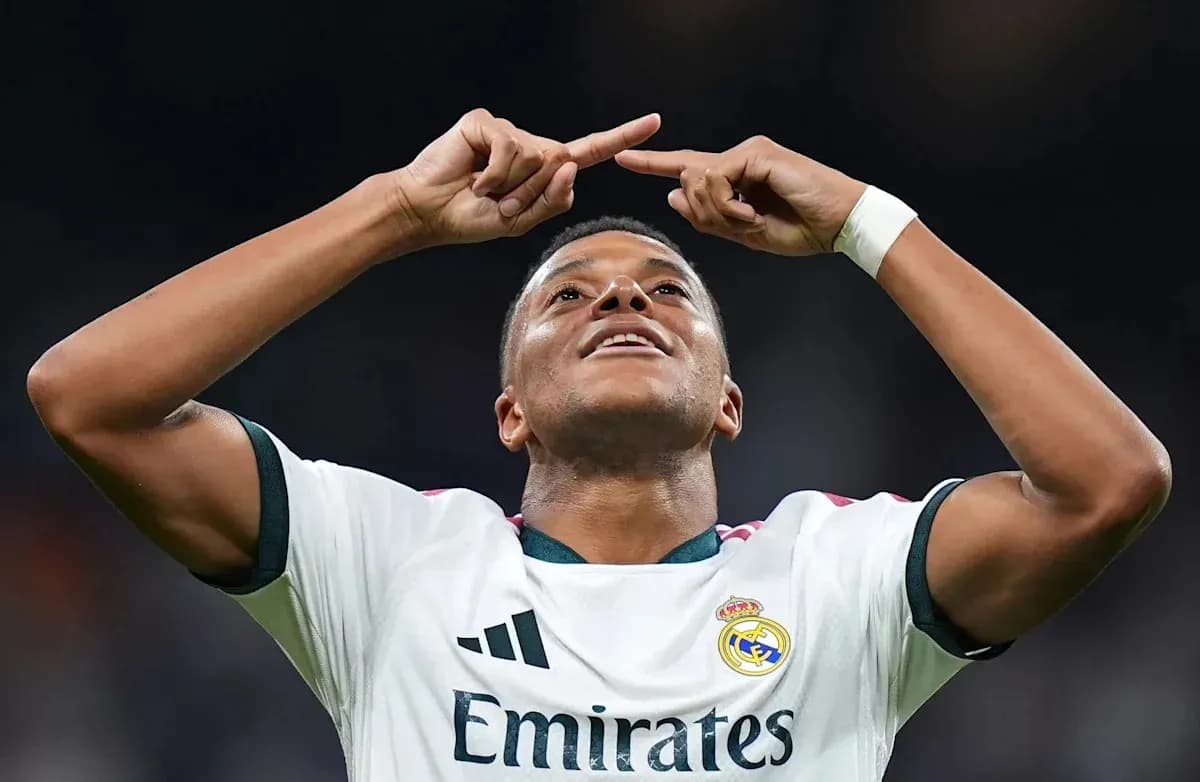 Player celebrating a goal with arms raised Player celebrating a goal with arms raised