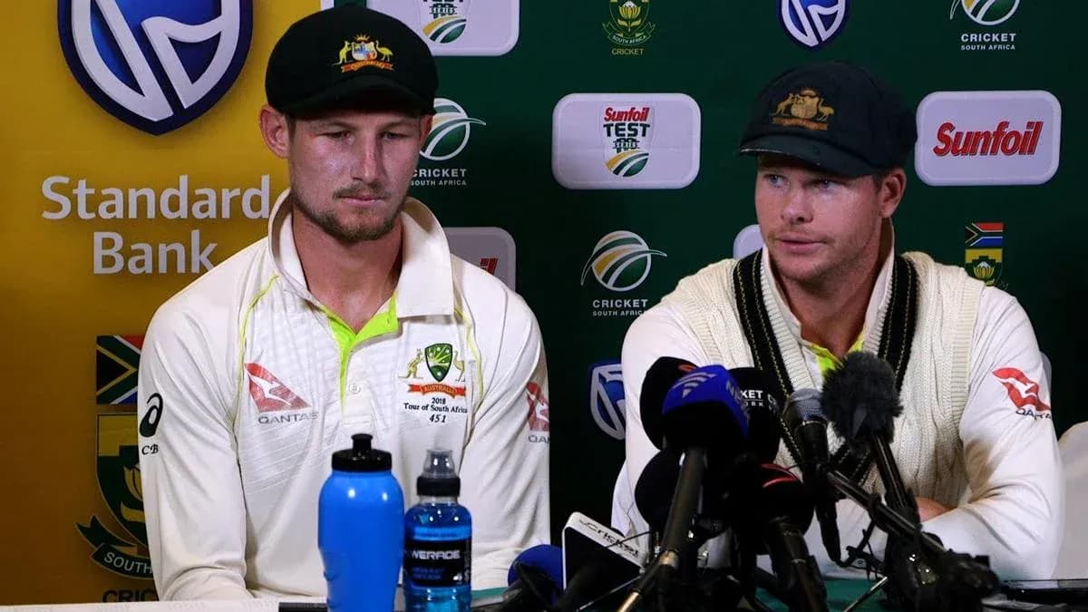 Two cricketers at press conference table with microphones Two cricketers at press conference table with microphones