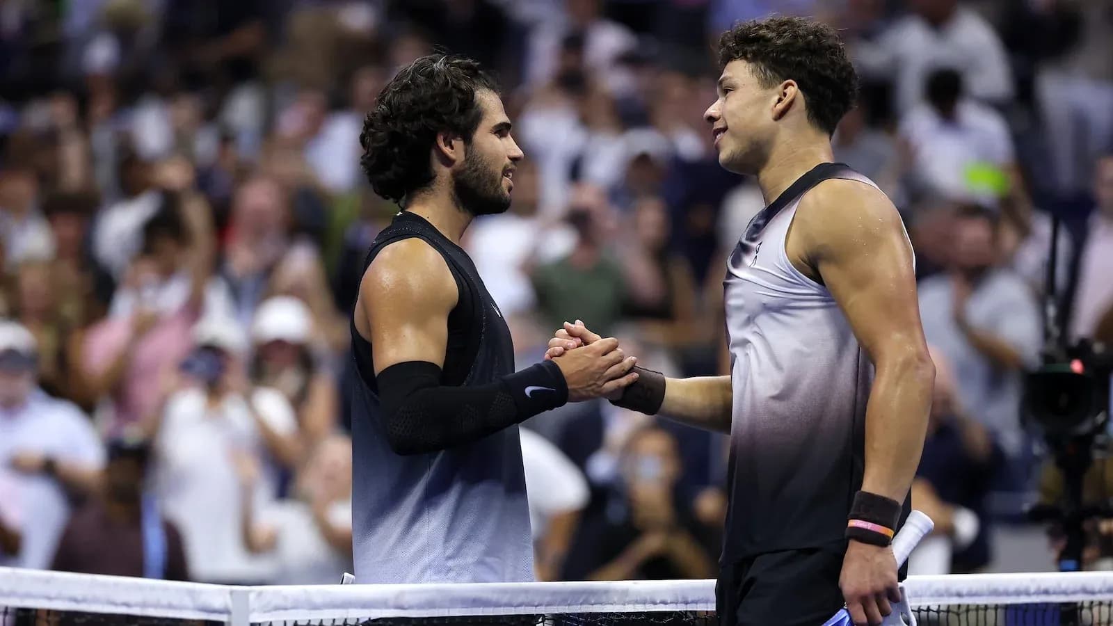 Two tennis players shaking hands at the net Two tennis players shaking hands at the net