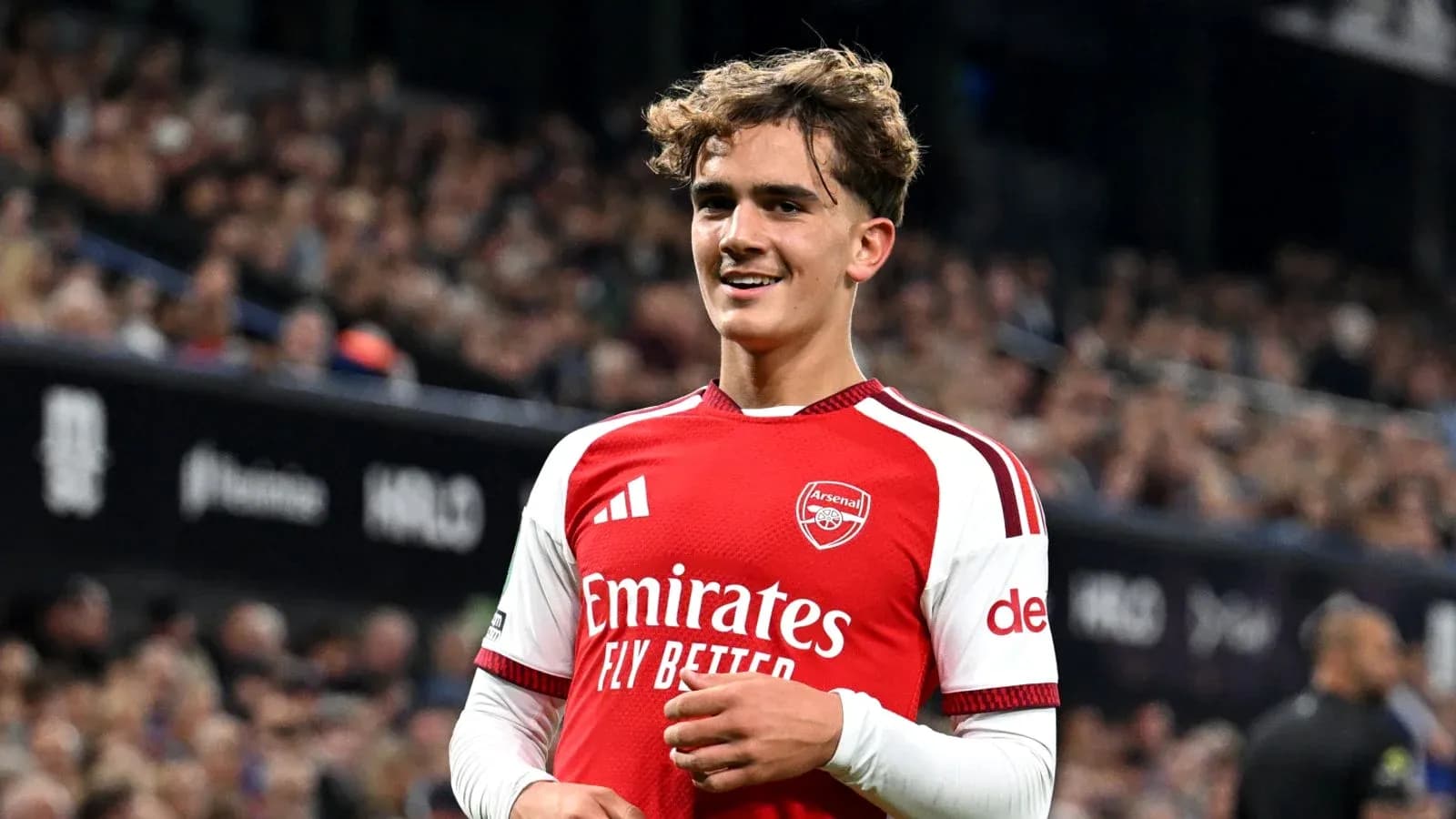 Arsenal player smiling on the pitch during match Arsenal player smiling on the pitch during match