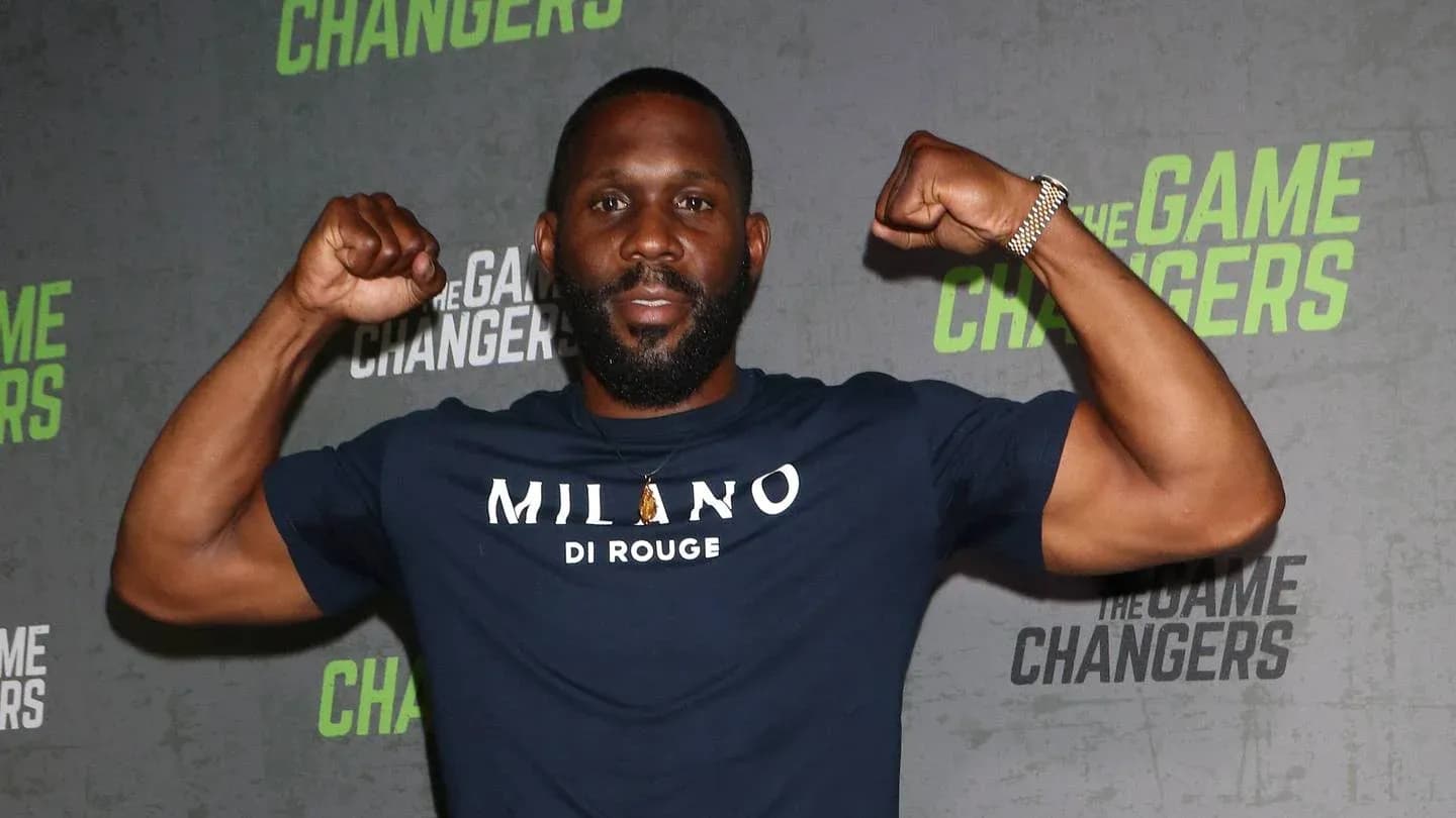 Man flexing muscles at promotional event backdrop Man flexing muscles at promotional event backdrop