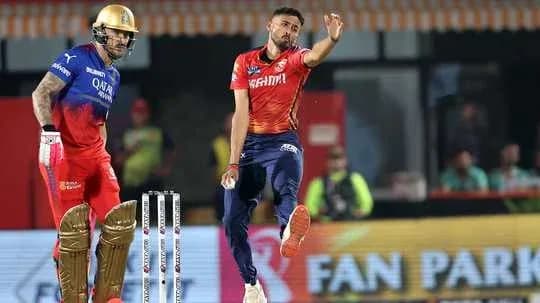 Bowler delivering ball while batsman prepares to hit Bowler delivering ball while batsman prepares to hit