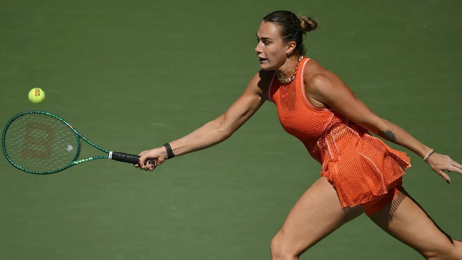 Player reaching for a tennis ball on court Player reaching for a tennis ball on court