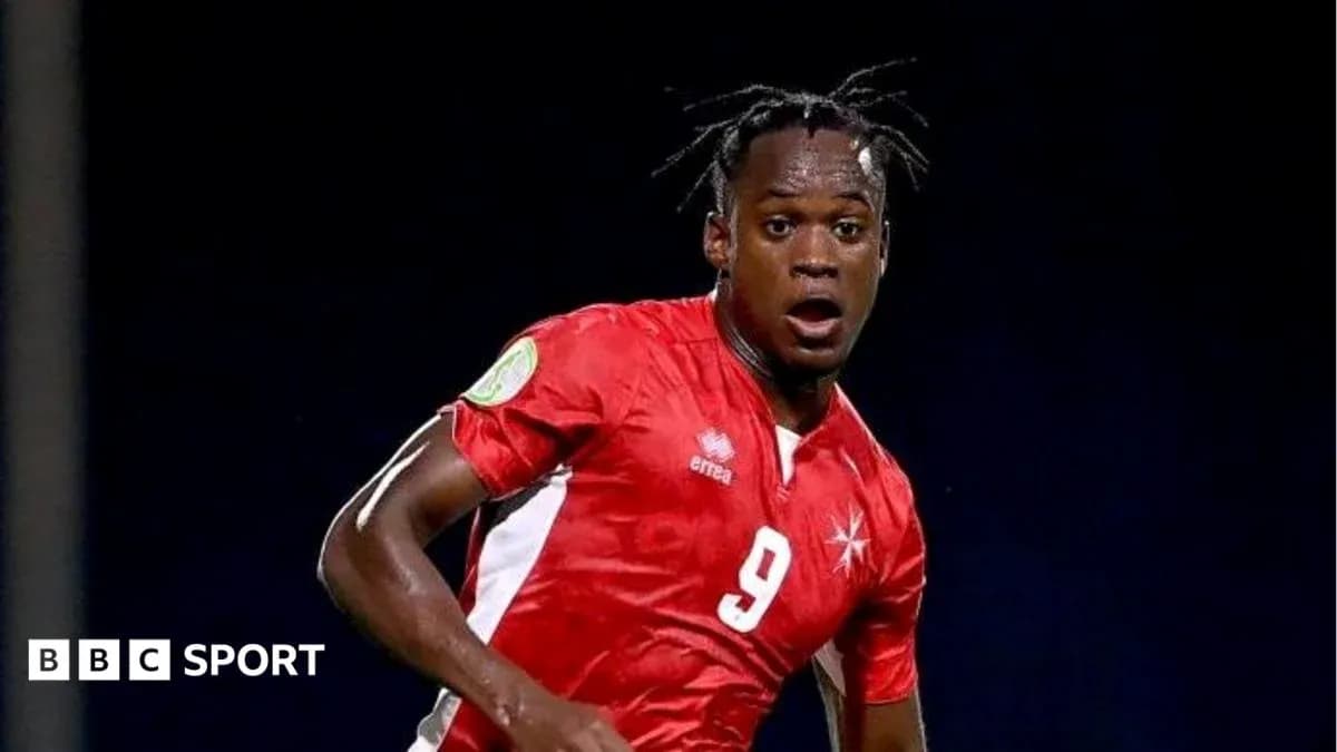 Player in red jersey during a soccer match Player in red jersey during a soccer match