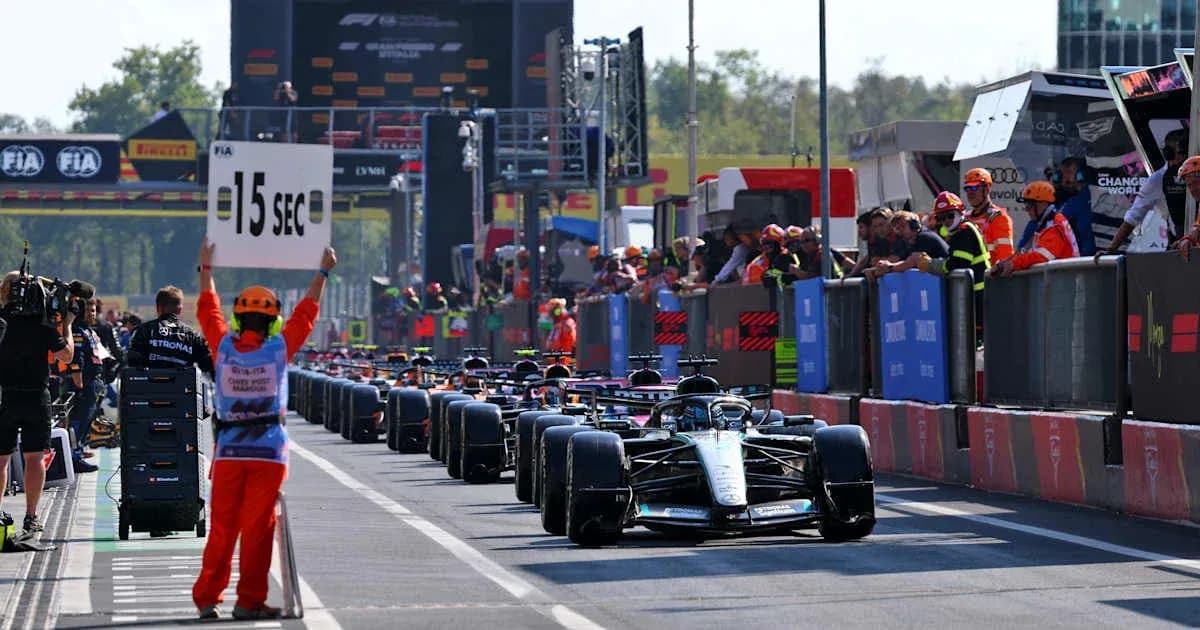 Pit lane with cars and officials during Formula 1 race Pit lane with cars and officials during Formula 1 race