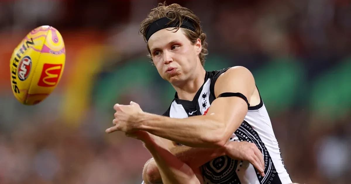 Player passing the ball during an AFL match Player passing the ball during an AFL match