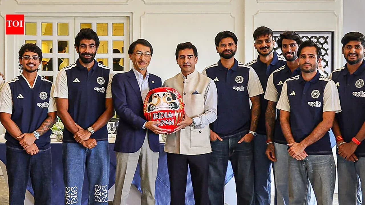 Cricket team posing with a Daruma doll Cricket team posing with a Daruma doll