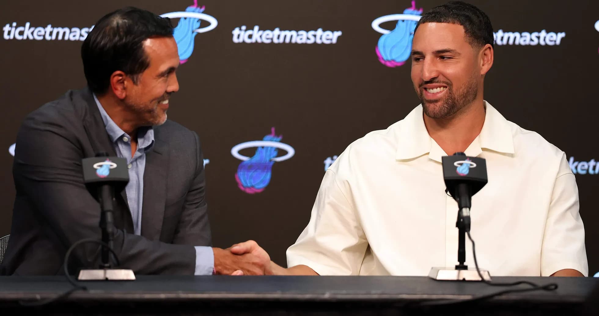 Coach and player shaking hands at press conference Coach and player shaking hands at press conference