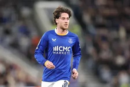 Player in blue jersey running on the field Player in blue jersey running on the field