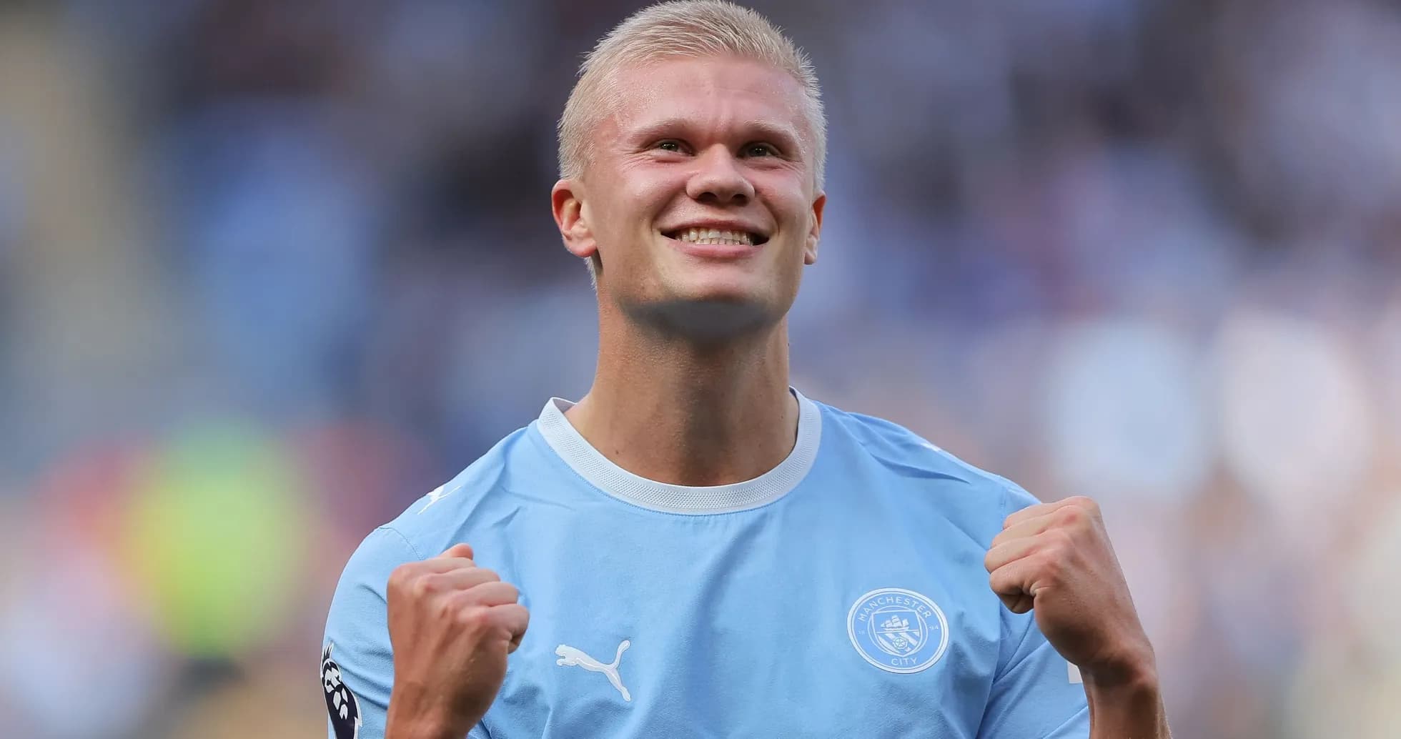 Player celebrating victory in Manchester City jersey Player celebrating victory in Manchester City jersey