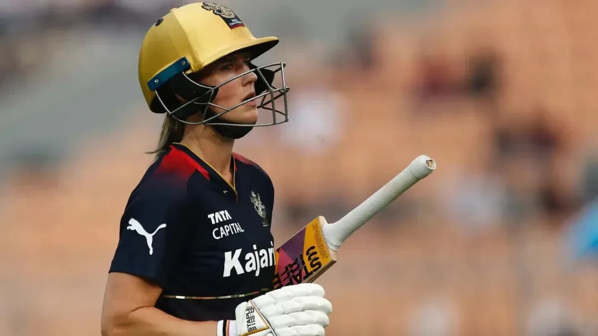 Cricketer wearing helmet and holding bat Cricketer wearing helmet and holding bat