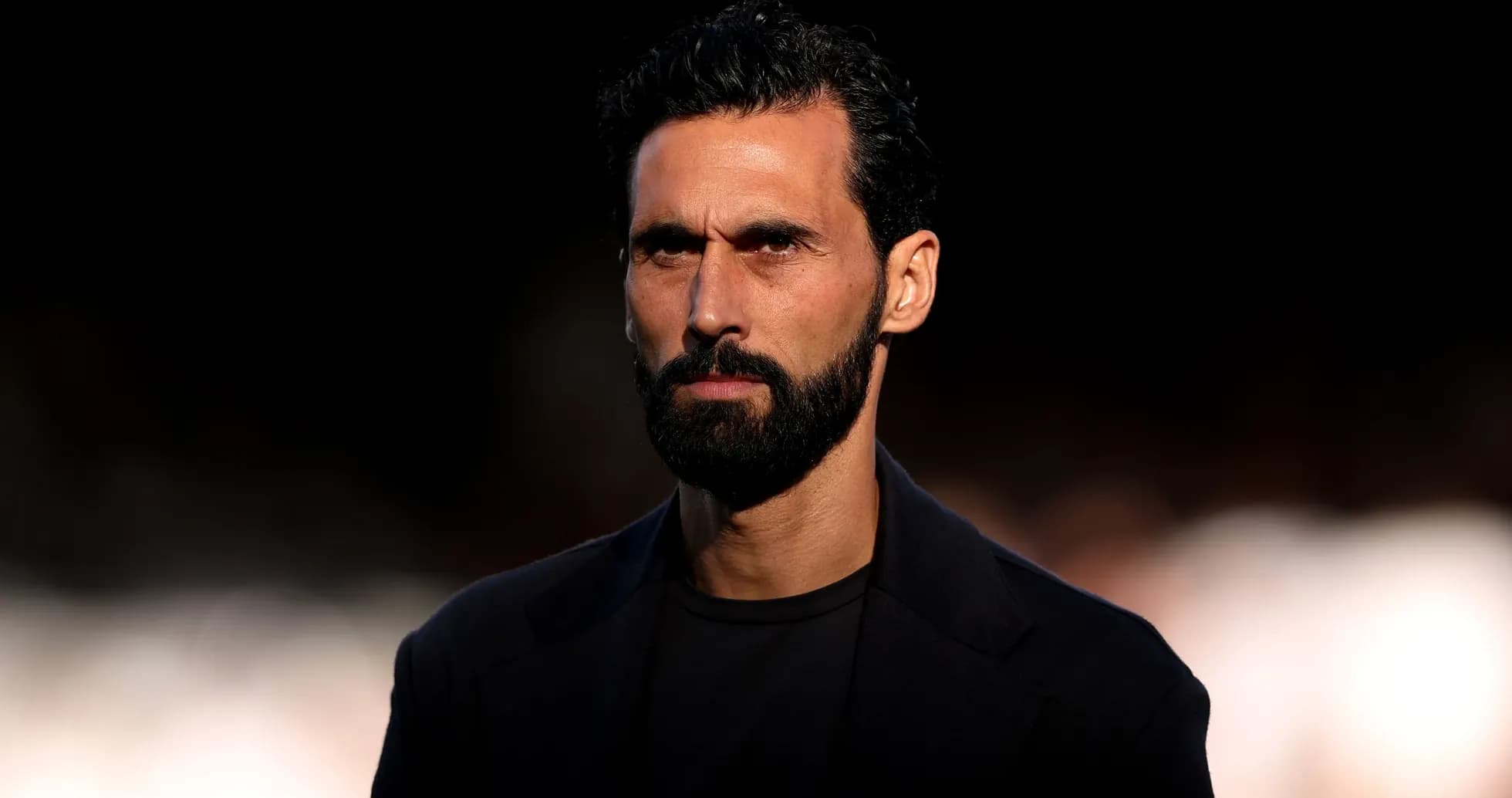 Man with beard looking serious against dark background Man with beard looking serious against dark background