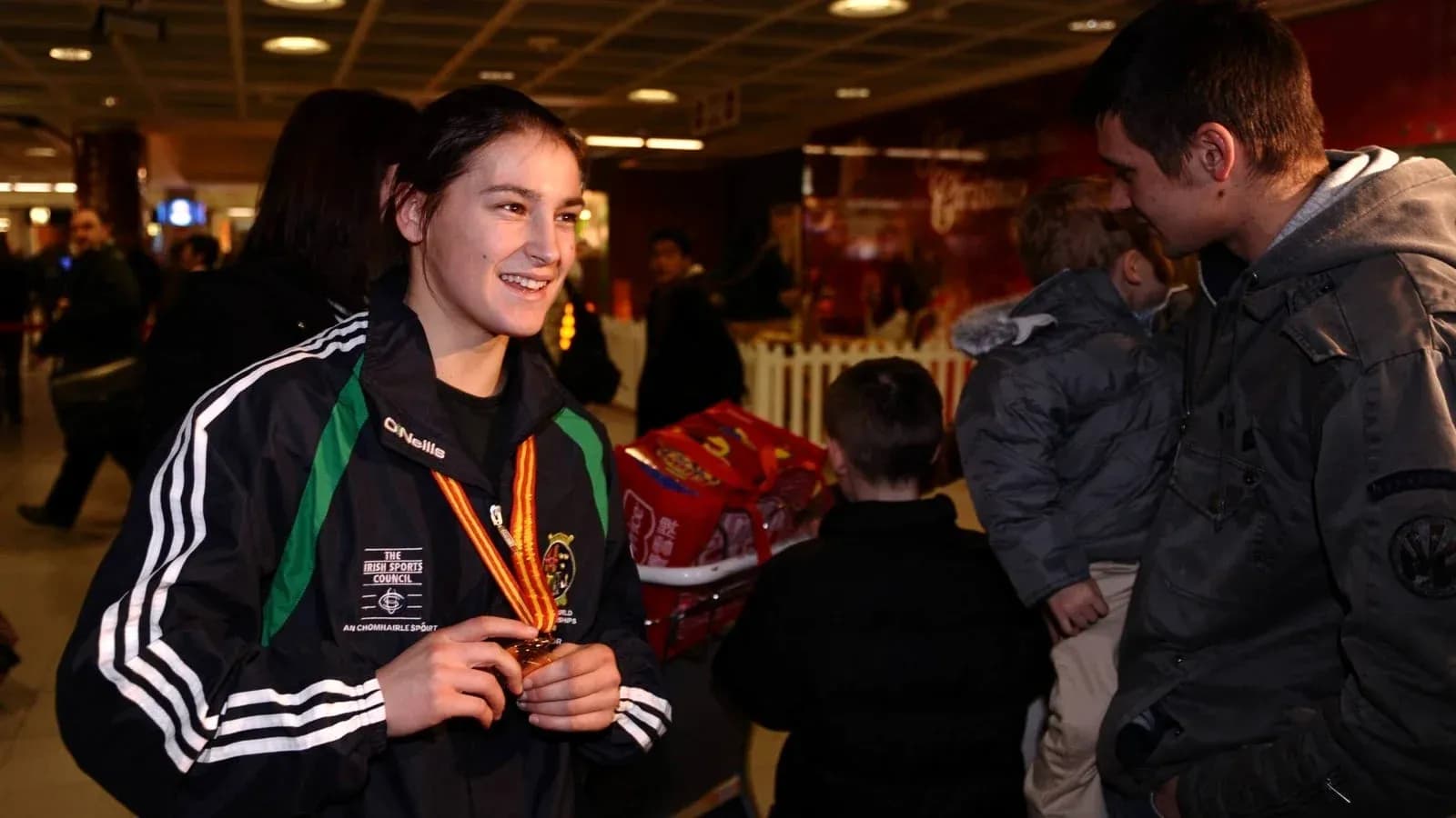 Athlete displaying medal at airport arrival Athlete displaying medal at airport arrival