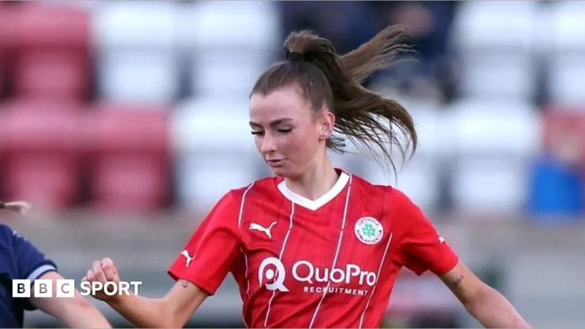 Player in red jersey dribbling the ball during match Player in red jersey dribbling the ball during match