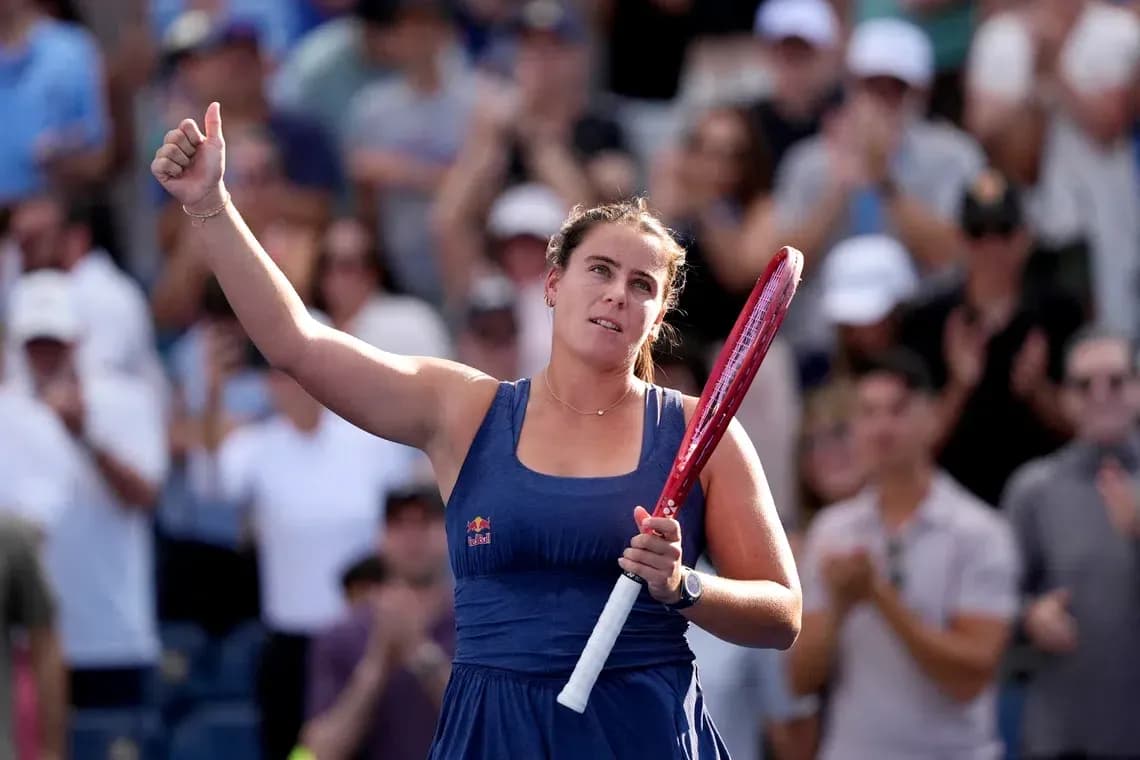 Tennis player celebrating with raised hand and racket Tennis player celebrating with raised hand and racket