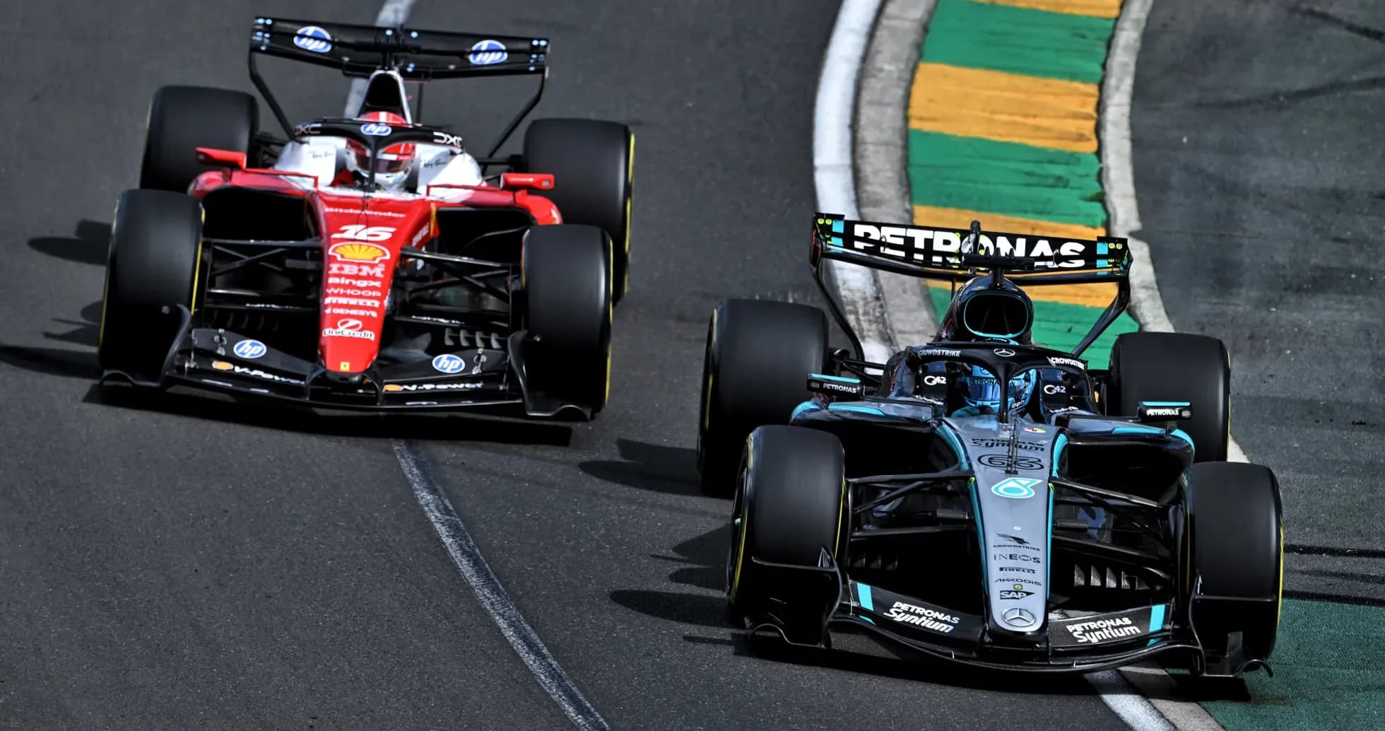 Two Formula 1 cars racing on track Two Formula 1 cars racing on track