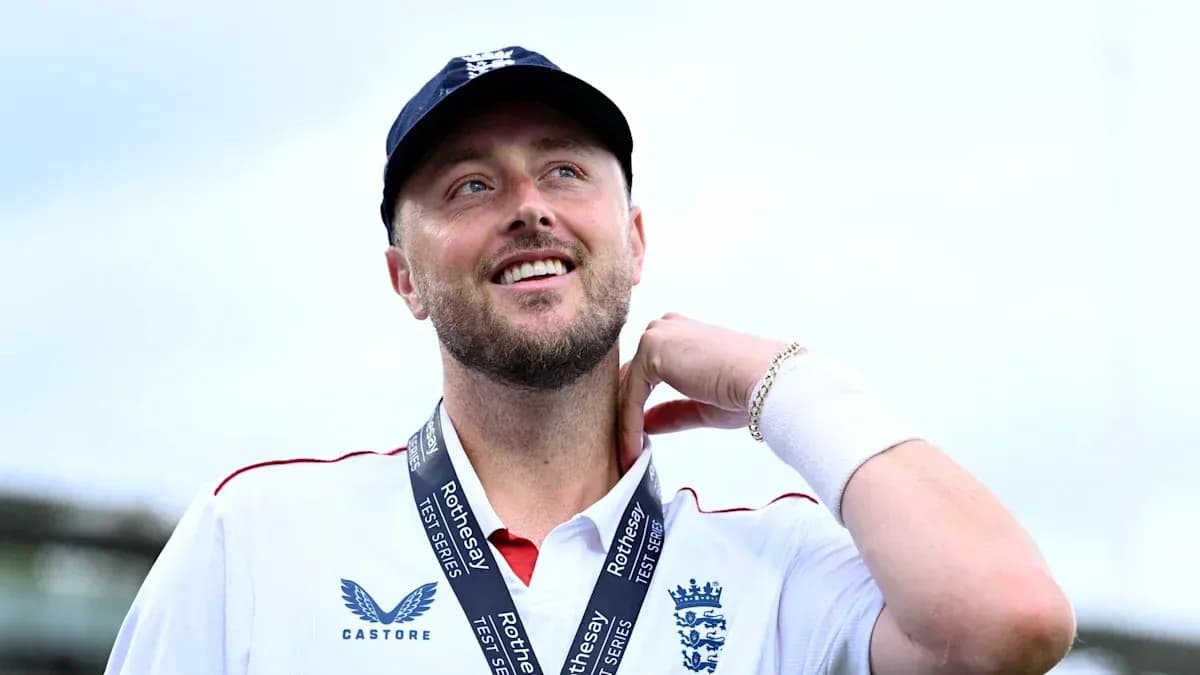 Cricketer wearing England jersey with medal around neck Cricketer wearing England jersey with medal around neck
