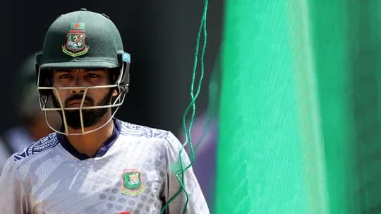 Cricketer wearing helmet near practice nets Cricketer wearing helmet near practice nets
