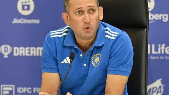 Coach speaking at a press conference with microphone Coach speaking at a press conference with microphone