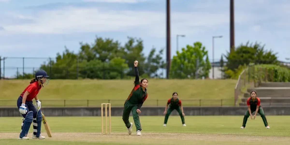 Bowler delivering ball with fielders in position Bowler delivering ball with fielders in position