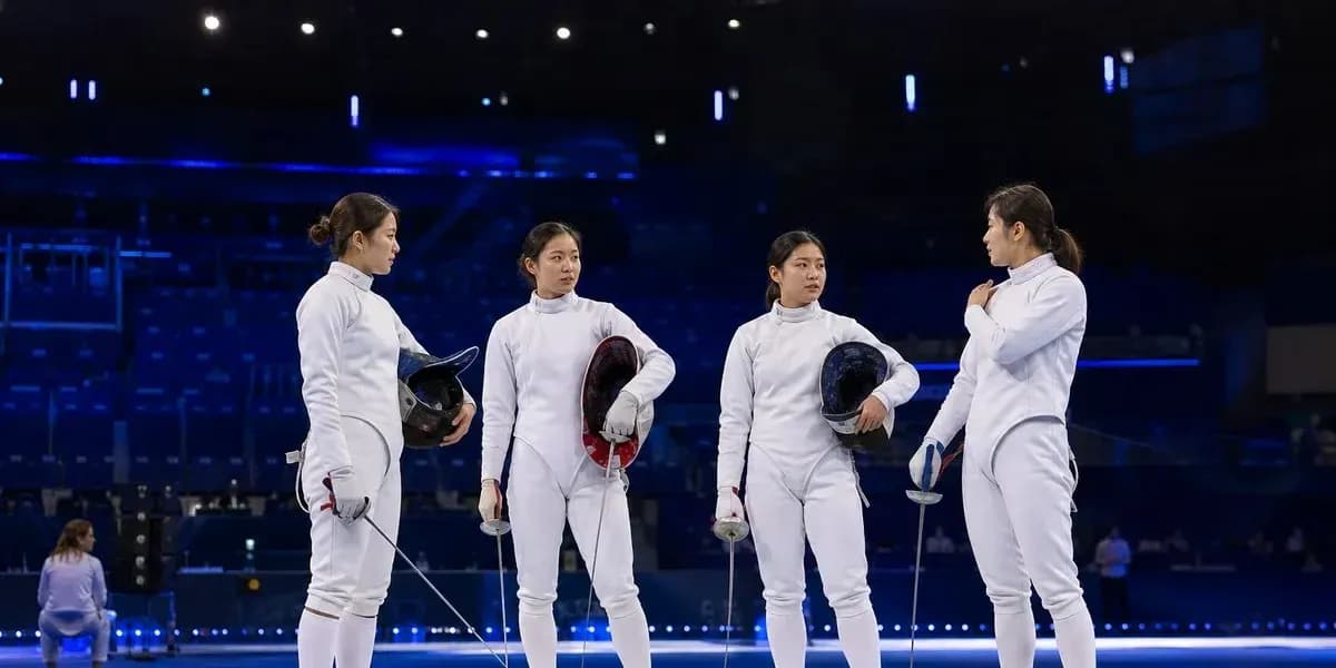 Four fencers discussing strategy on the piste Four fencers discussing strategy on the piste