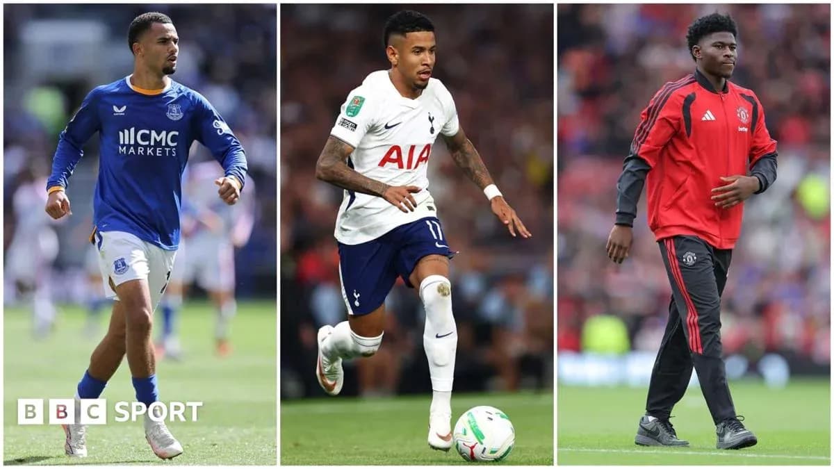 Three football players in team kits during match Three football players in team kits during match