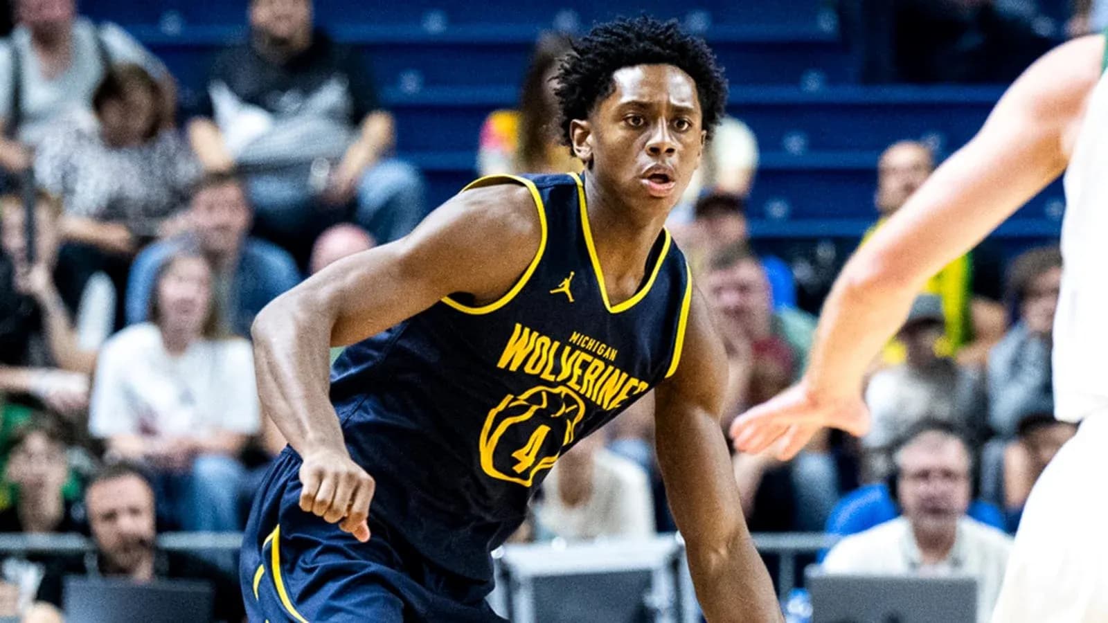 Player from Michigan Wolverines dribbling during game Player from Michigan Wolverines dribbling during game