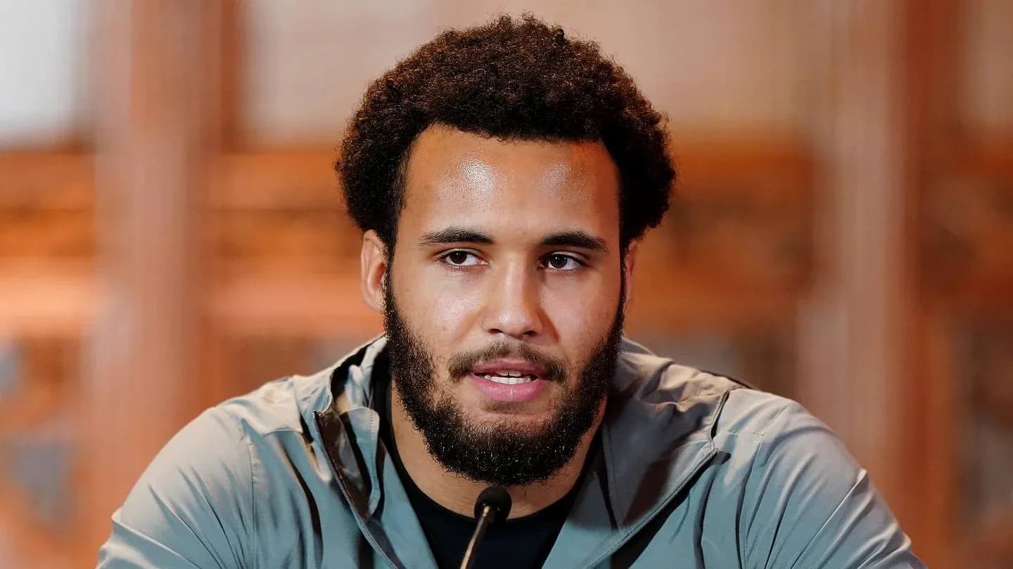 Athlete speaking at press conference with microphone Athlete speaking at press conference with microphone