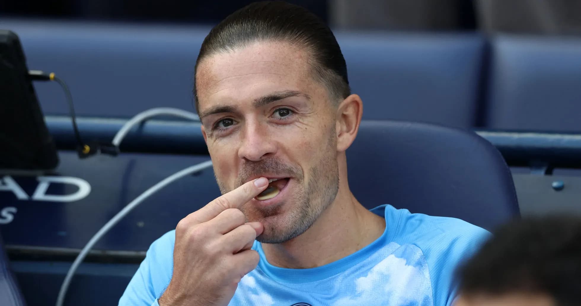 Player seated on bench, eating snack during match Player seated on bench, eating snack during match