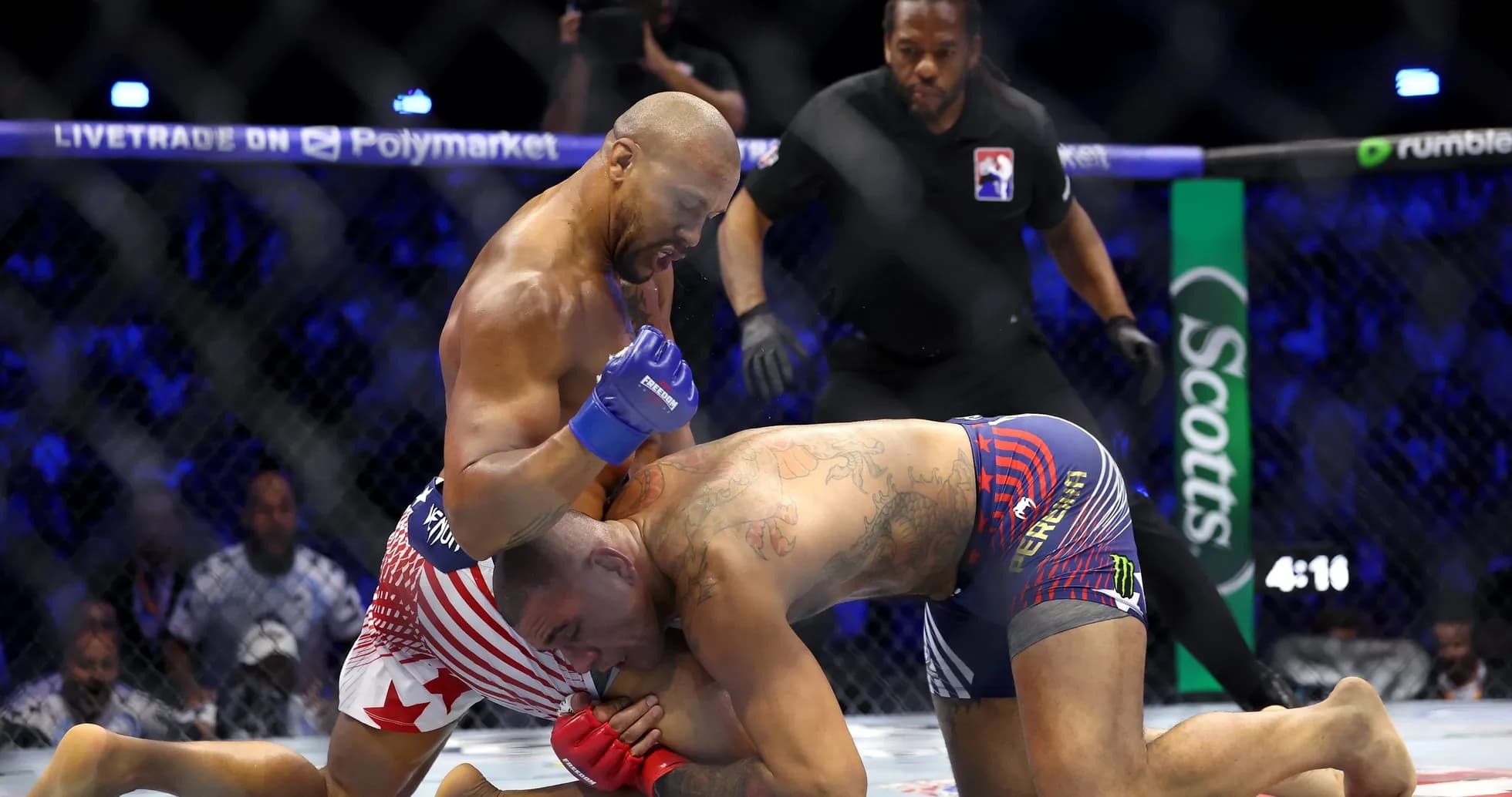 Fighters grappling in the octagon during match Fighters grappling in the octagon during match