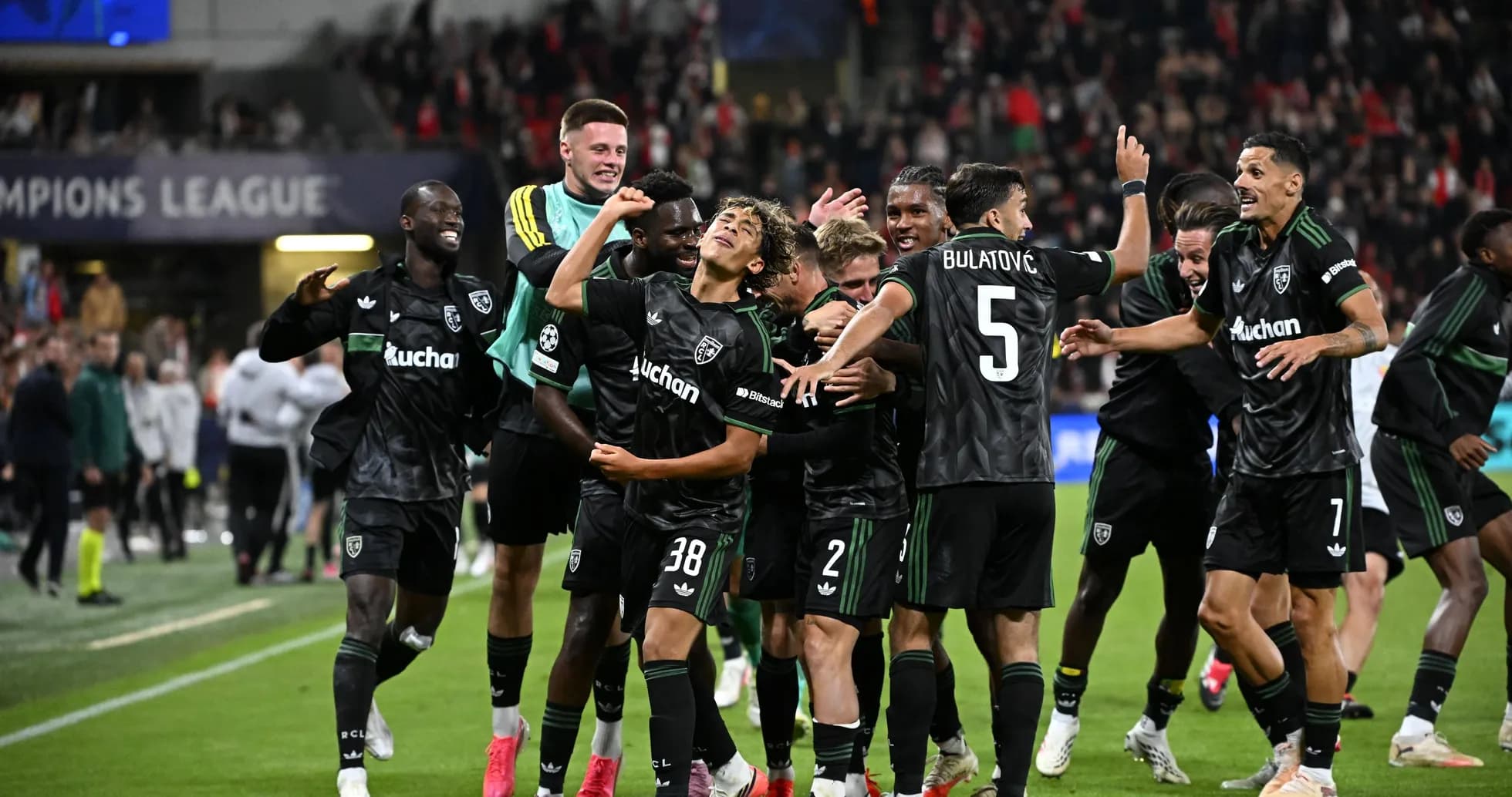 Players celebrating after a Champions League match victory Players celebrating after a Champions League match victory