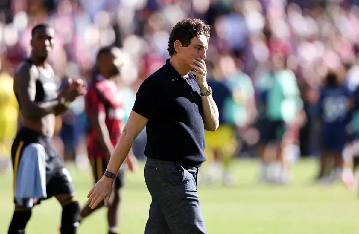 Coach walking on field after match conclusion Coach walking on field after match conclusion