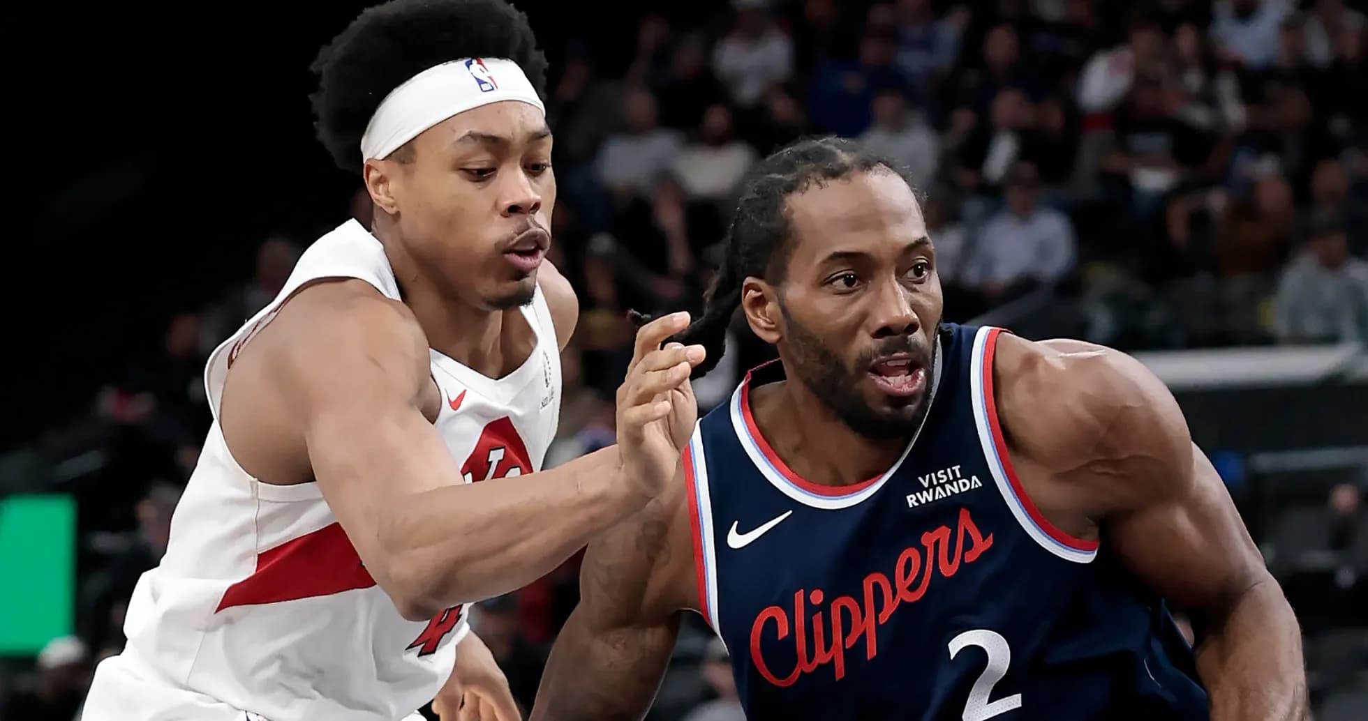 Two players competing for the ball during a game Two players competing for the ball during a game